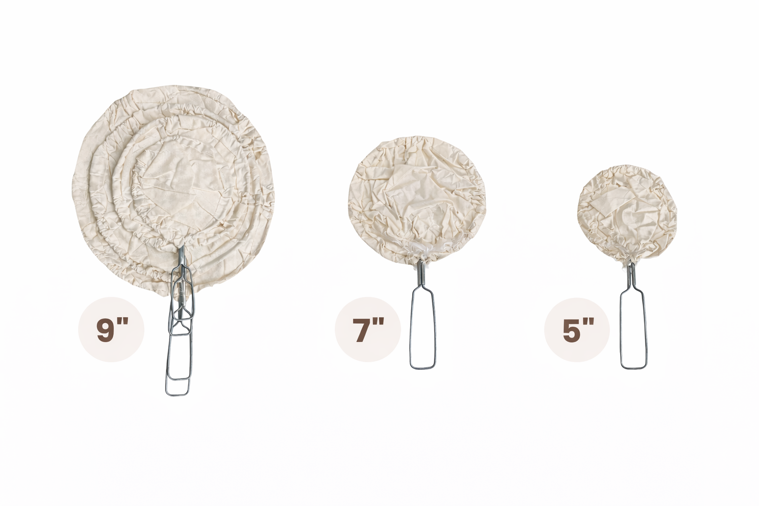 Set of three round parchment paper liners with metal lifting handles in sizes 9", 7", and 5".
