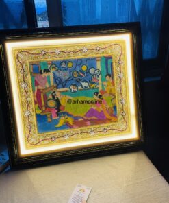 Ornate framed painting on display, brightly lit from within the frame; a small card sits on a beige surface nearby in a blue-toned gallery setting.