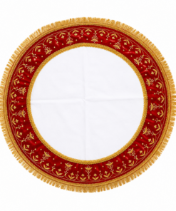 Circular decorative cloth with a red velvet border, gold embroidery and fringe surrounding a white center.