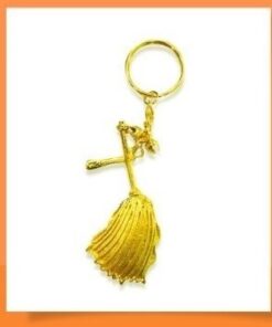 Gold-tone cross pendant keychain with a fringed tassel on a white background