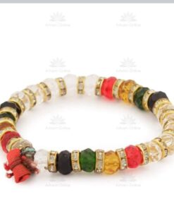 Colorful beaded bracelet with gold-tone spacers and a red tassel at the end, arranged in a circle.