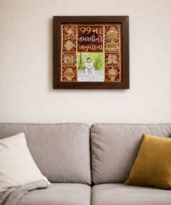 Framed colorful Indian artwork hung above a light gray sofa with white and mustard cushions in a living room.