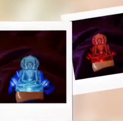 Two overlapping Polaroid-style photos showing a blue glowing statue on a brown pedestal against a dark background.