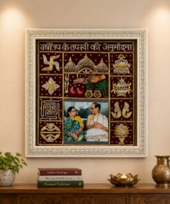 Framed Indian embroidery artwork with a central couple’s photo surrounded by gold-embellished panels on a beige wall