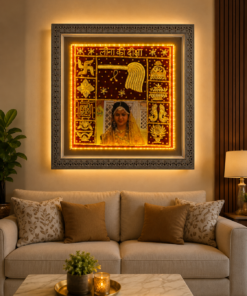 Framed, illuminated Indian artwork above a beige sofa with rust-colored cushions.