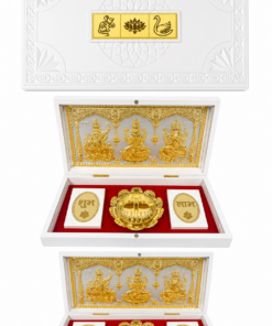 White decorative multi-tier box opened to reveal gold Hindu deities panel and coin thalis on red lining with white cases labeled शुभ and लाभ (Shubh and Laabh).