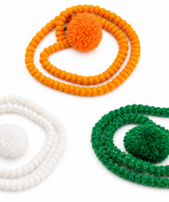 Three beaded bracelets with large pom-poms in orange, white, and green laid in circular shapes on a white background.