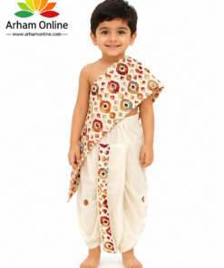 Smiling young boy in cream traditional outfit with a patterned sash, standing barefoot against a white background; Arham Online logo in the top left.