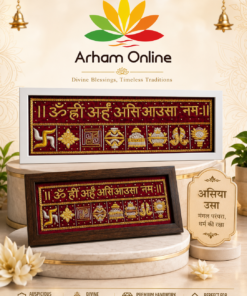 Framed red and gold religious embroidery panel with Hindu symbols and Sanskrit text on a marble pedestal.