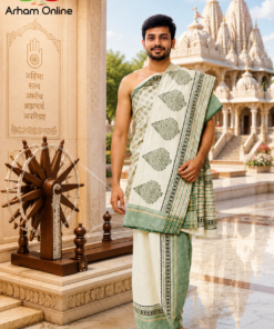 Man in a pale green and cream saree stands barefoot in a temple courtyard, with ornate temple structures behind and the Arham Online logo visible in the corner.